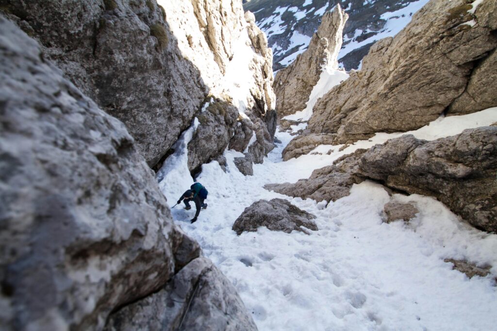 pexels photo 306531 306531 A climber ascends a snowy rocky mountain terrain, showcasing winter adventure and nature's challenge.